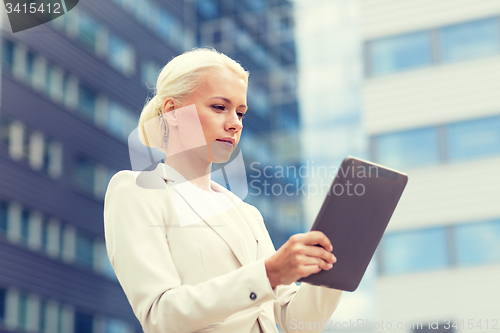Image of businesswoman working with tablet pc outdoors