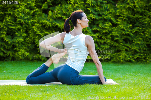 Image of beautiful adult woman doing yoga