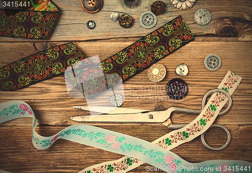 Image of vintage lace, buttons and a dressmaker scissors