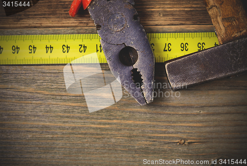 Image of vintage pliers and old hammer