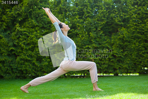 Image of pretty adult woman doing yoga