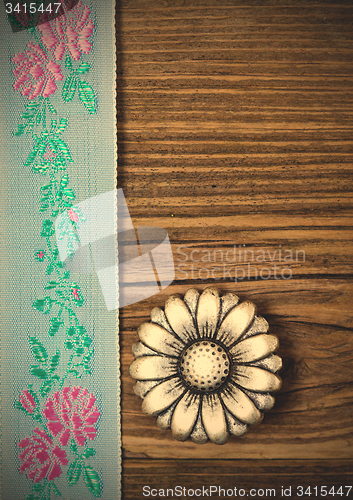 Image of vintage aqua color tape with embroidered ornaments and old butto