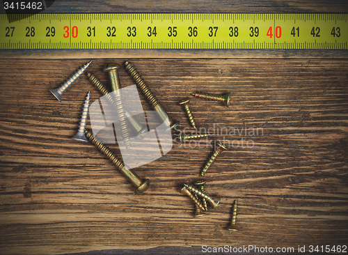 Image of screw and measuring tape