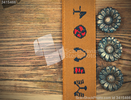 Image of vintage buttons and old tape with embroidered ornaments