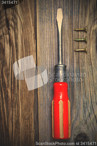 Image of old screwdriver, three screws