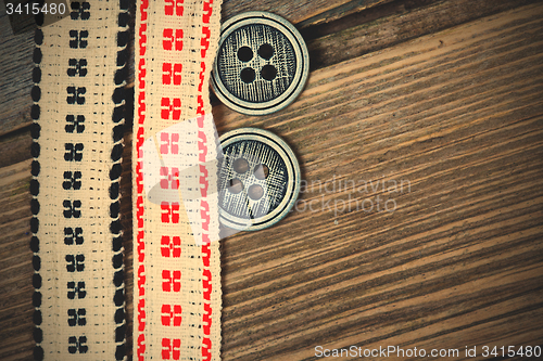 Image of vintage bands with embroidered ornaments and old buttons