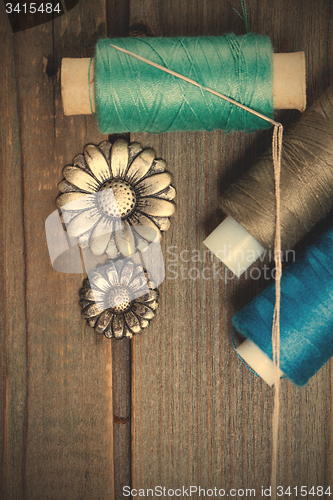 Image of vintage buttons flowers and spools with threads