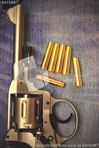 Image of Nagant revolver with cartridges