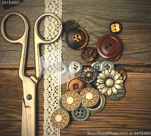 Image of vintage buttons, tape lace and a tailor scissors 