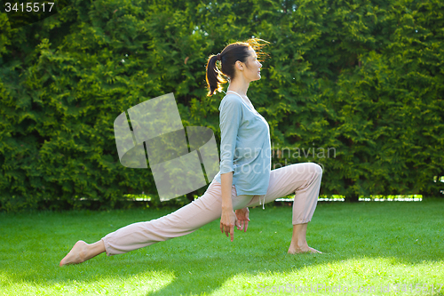 Image of beautiful adult woman doing yoga