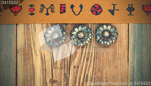 Image of vintage band with embroidered ornaments and old button