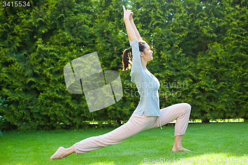 Image of beautiful adult woman doing yoga