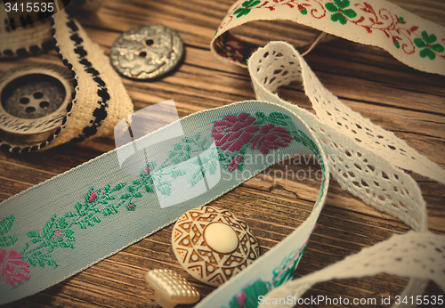 Image of vintage ribbons, lace, tape and buttons