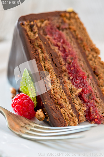 Image of Piece of chocolate cake with raspberries.