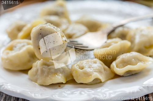 Image of Dumplings with butter and black pepper.