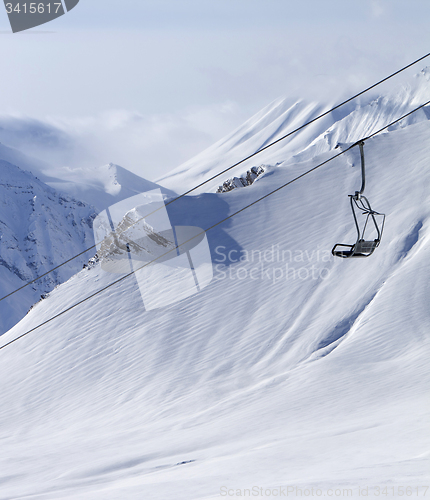 Image of Chair lift at ski resort and off piste slope