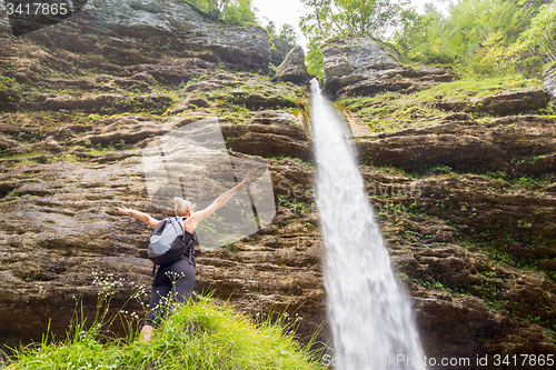 Image of Active sporty woman relaxing in beautiful nature.