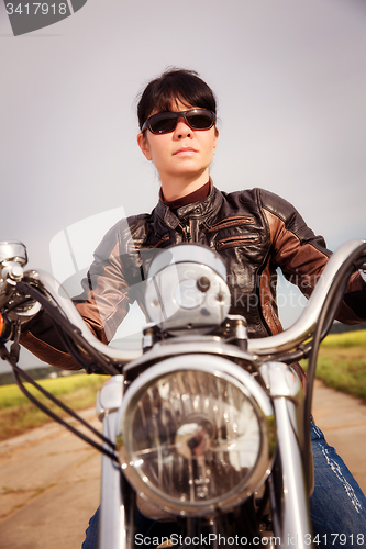 Image of Biker girl on a motorcycle