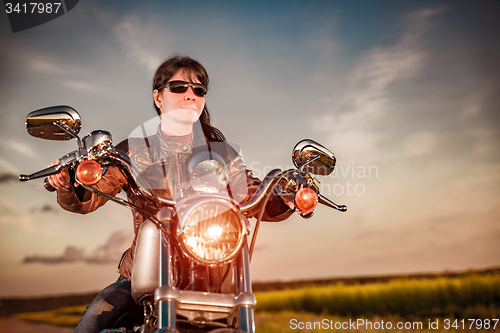 Image of Biker girl on a motorcycle