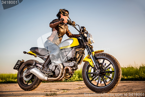 Image of Biker girl on a motorcycle