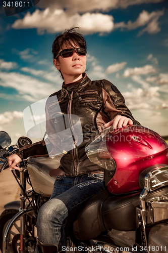 Image of Biker girl on a motorcycle