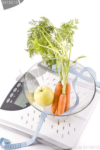 Image of carrots, apple and measuring objects
