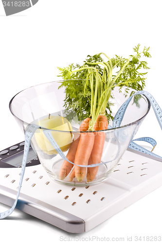 Image of carrots, apple and measuring objects