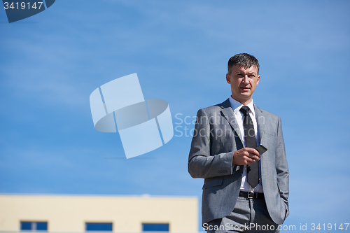 Image of senior  businessman outdoors