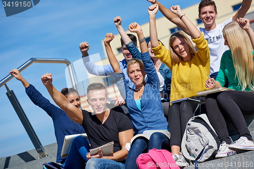 Image of students outside sitting on steps