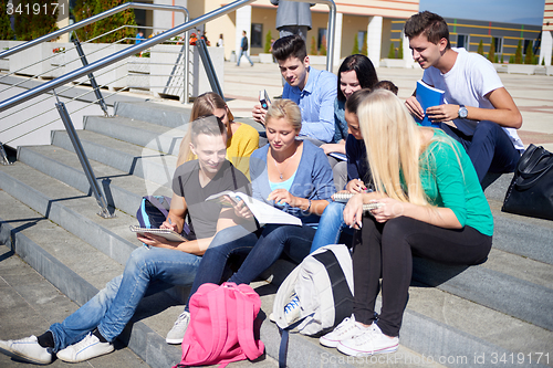 Image of students outside sitting on steps