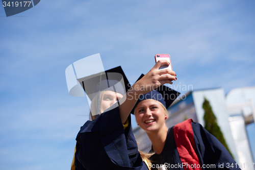 Image of students group in graduates making selfie