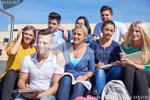 Image of students outside sitting on steps