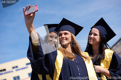 Image of students group in graduates making selfie