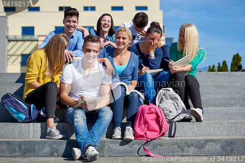 Image of students outside sitting on steps