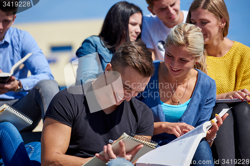 Image of students outside sitting on steps