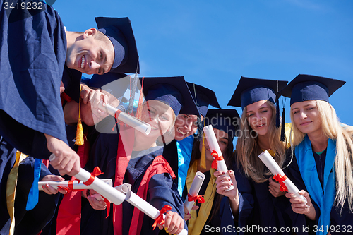 Image of young graduates students group