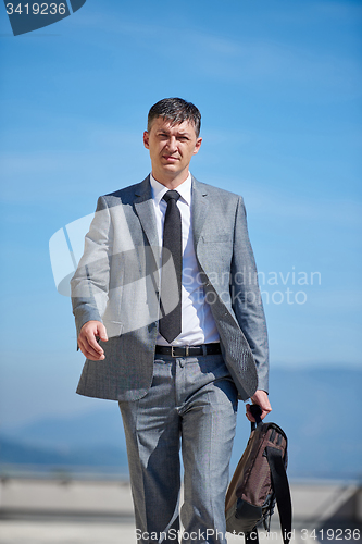 Image of senior  businessman outdoors