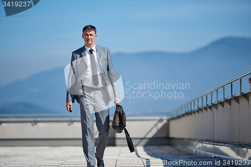 Image of senior  businessman outdoors