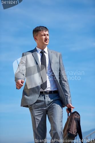Image of senior  businessman outdoors