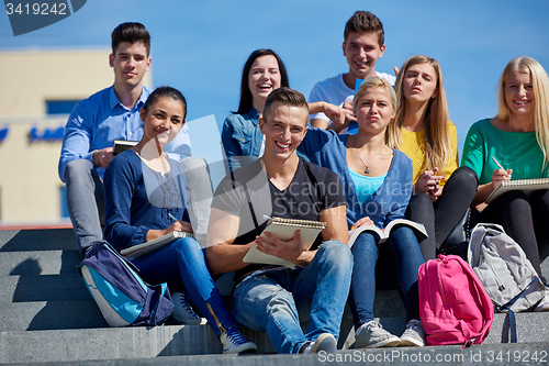 Image of students outside sitting on steps