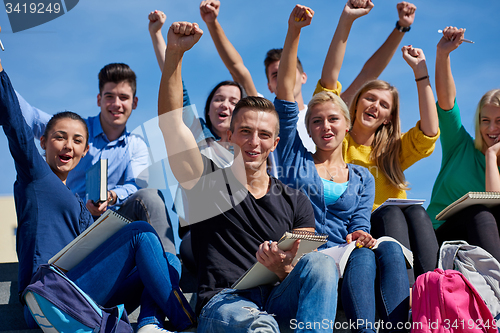 Image of students outside sitting on steps