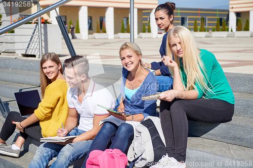 Image of students outside sitting on steps