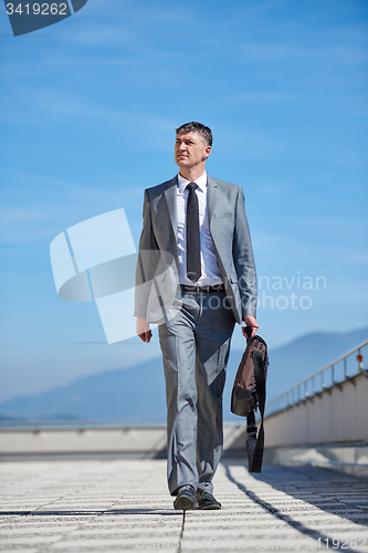Image of senior  businessman outdoors
