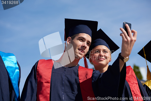 Image of students group in graduates making selfie