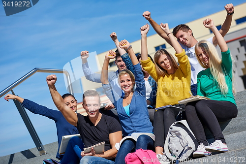 Image of students outside sitting on steps