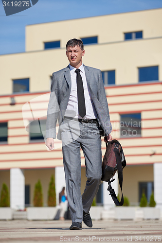 Image of senior  businessman outdoors