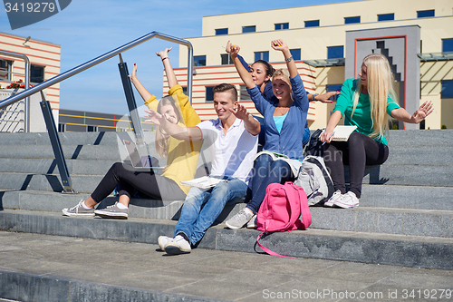 Image of students outside sitting on steps