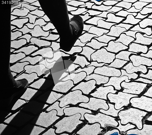 Image of Walking legs on pavement in the sun, with shades