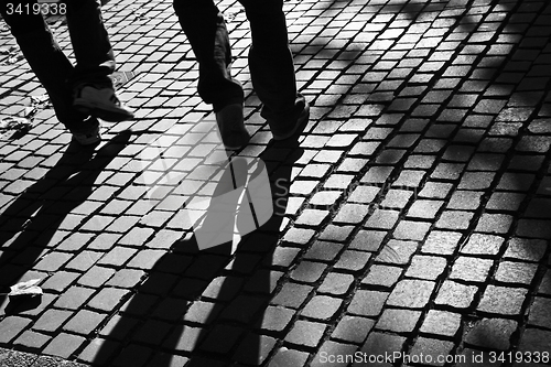 Image of Walking legs on pavement in the sun, with shades