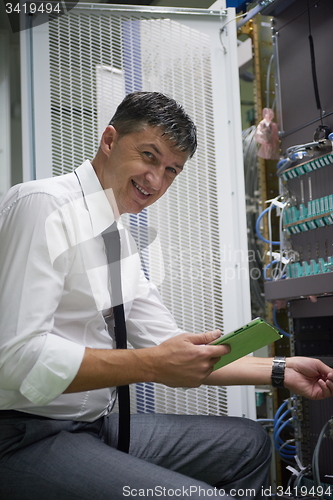 Image of network engineer working in  server room